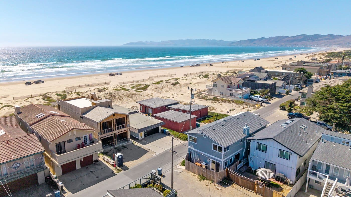 Vehicles parked on the wide sand at the Oceano Dunes